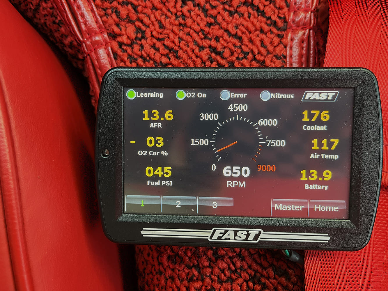 22 FAST handheld shows 176°F coolant 13 6 AFR and 650 RPM on a classic EFI setup