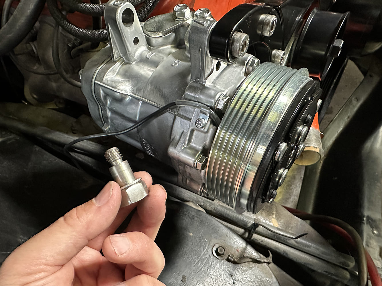 24 Sanden SD7 AC compressor installed with clutch wire and low mount bracket visible