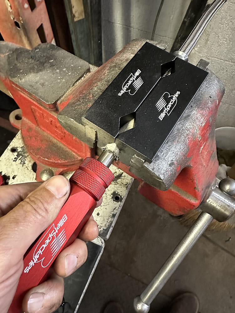 31 Billet Specialties braided hose clamp tool used to cut stainless line cleanly in vice setup