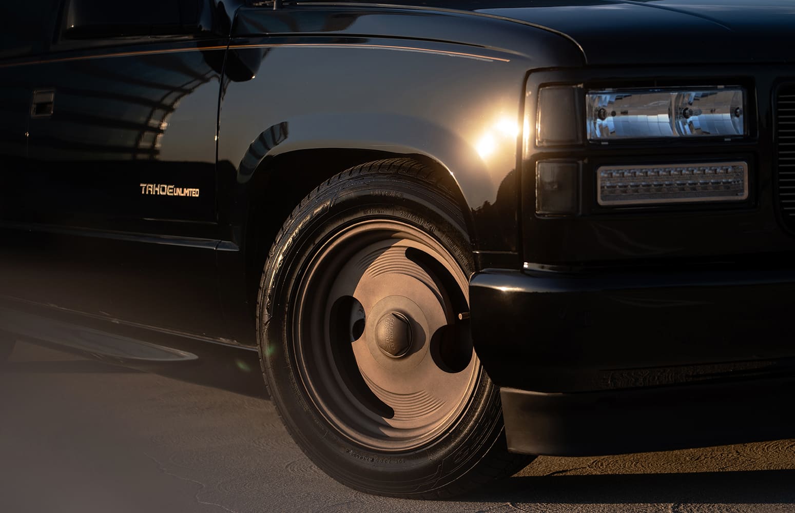 32 1990s Chevrolet Tahoe runs custom Cerakoted Slater wheels with period correct center caps