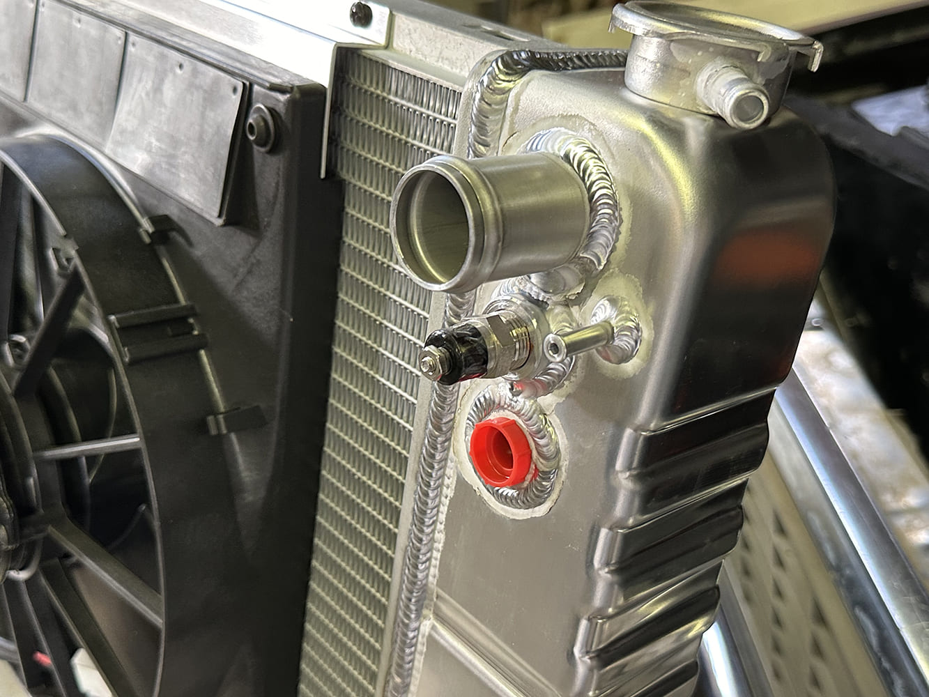 33 Close up of radiator upper neck fan sensor bung and TIG welded aluminum craftsmanship