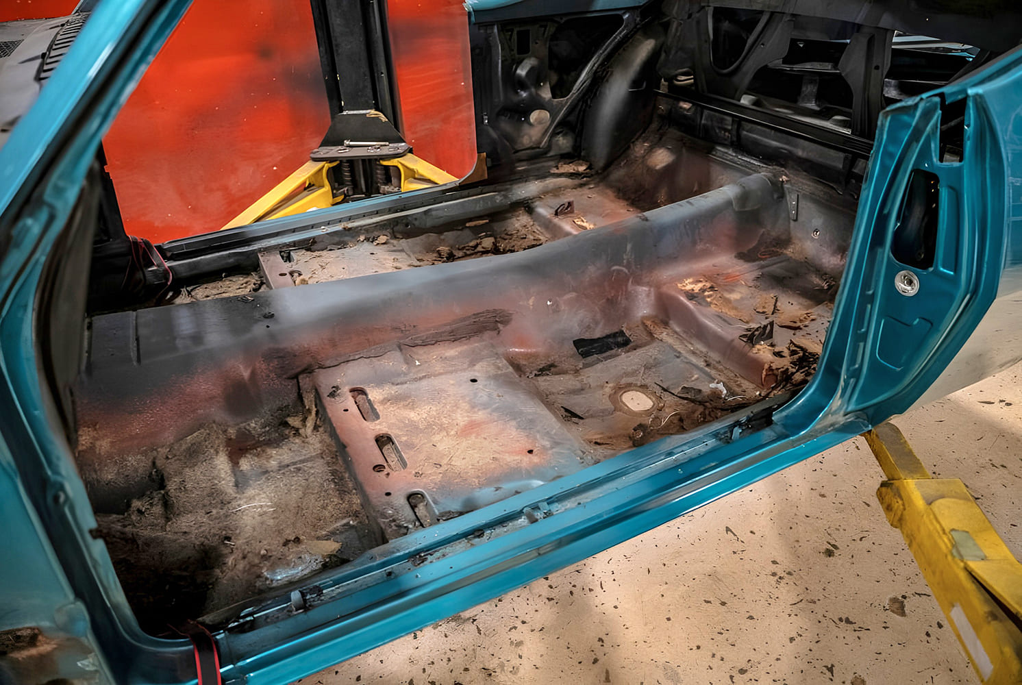 002 1968 Camaro interior stripped to bare metal floor pan showing rust and age before restoration