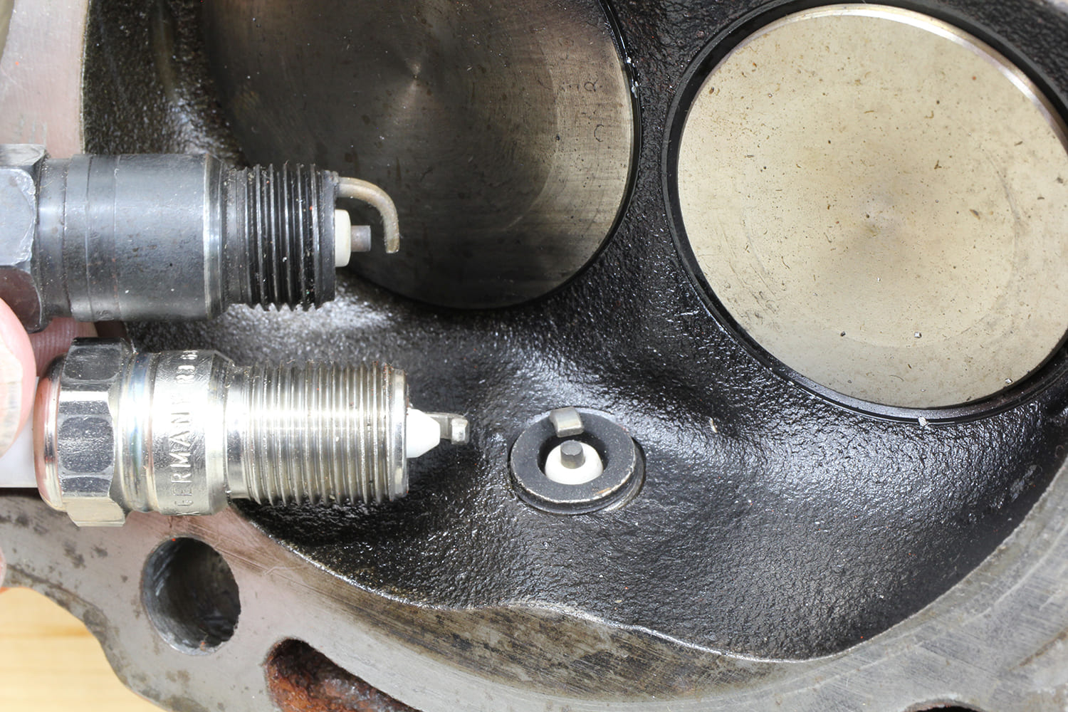 002 Cylinder head showing three spark plug styles installed and compared for seat type and reach depth