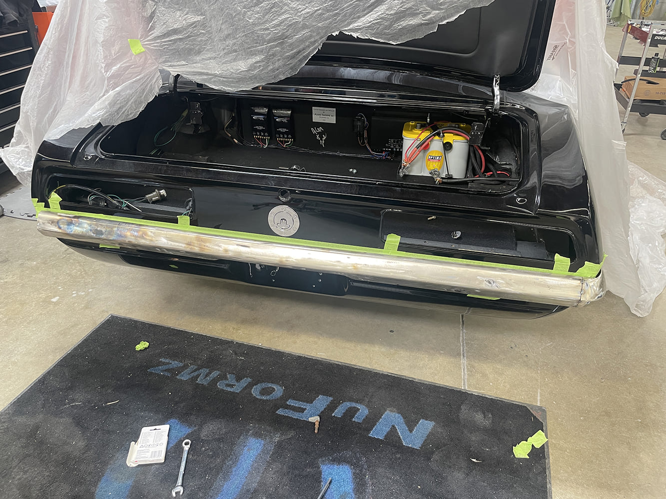 003 1969 Camaro rear bumper test fitted in raw metal finish taped for mock up alignment