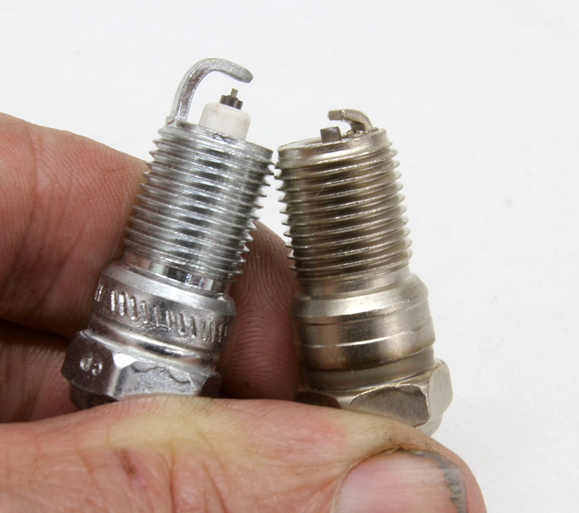 004 Visual comparison of two spark plugs with different ground strap angles and center electrode protrusion
