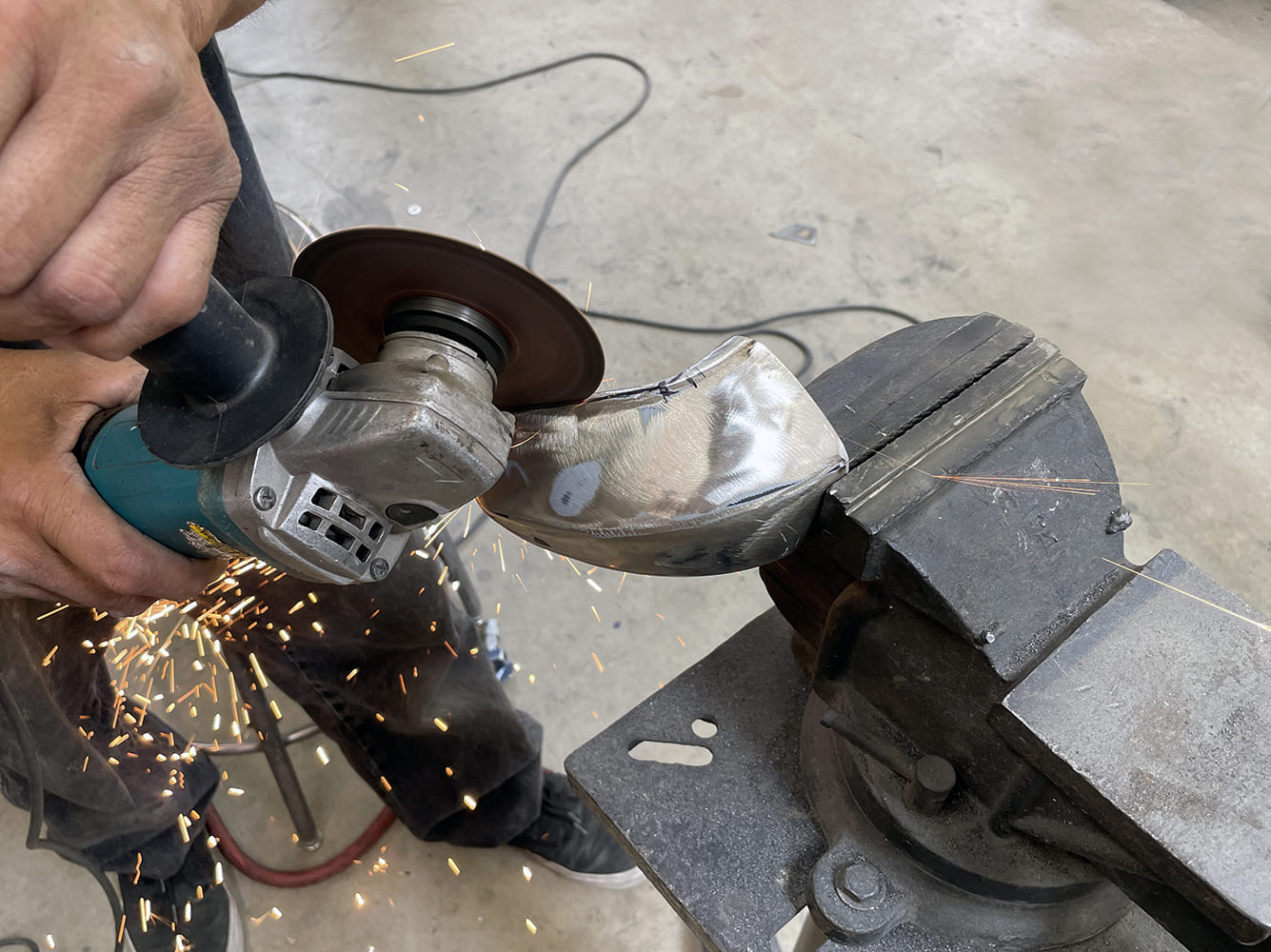 005 1969 Camaro bumper corner trimmed with angle grinder for precision contouring