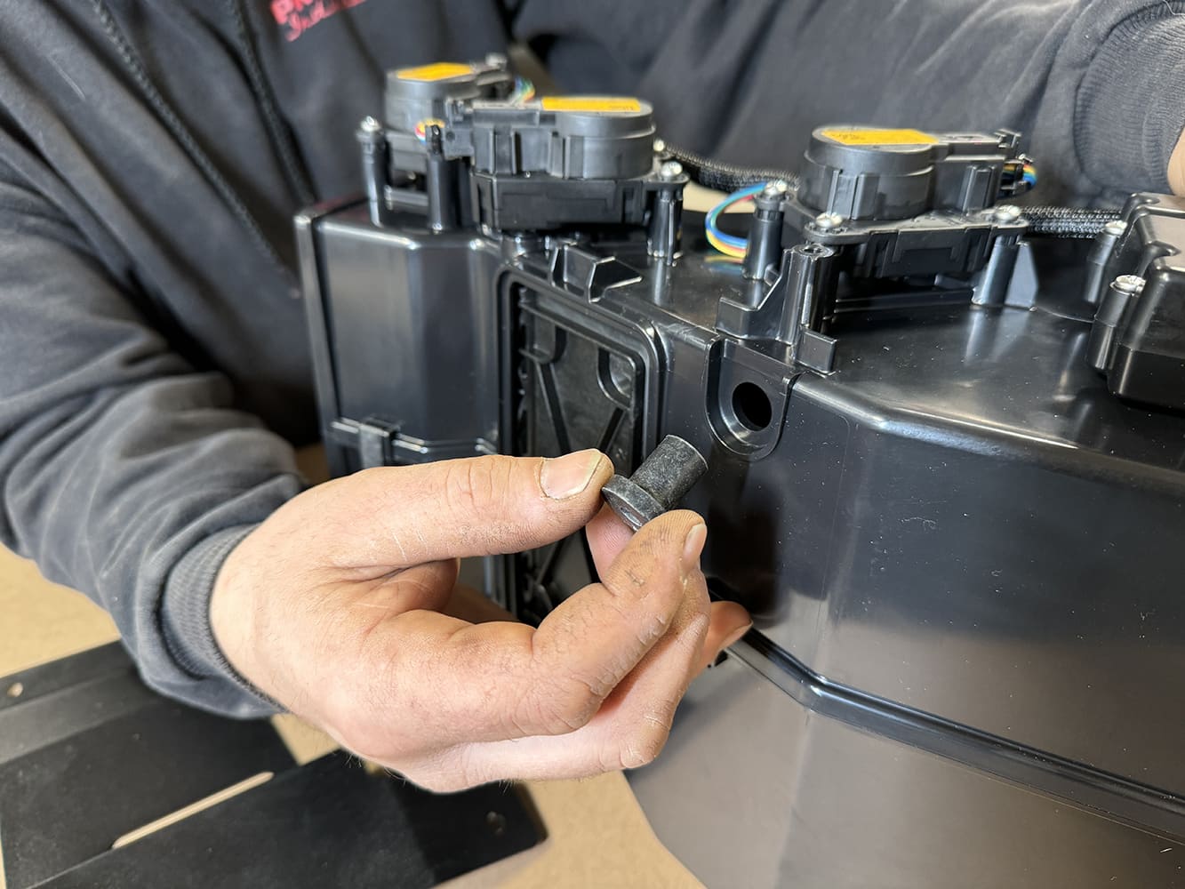 007 Technician fits grommet for wiring pass through on a 1971 Camaro evaporator case