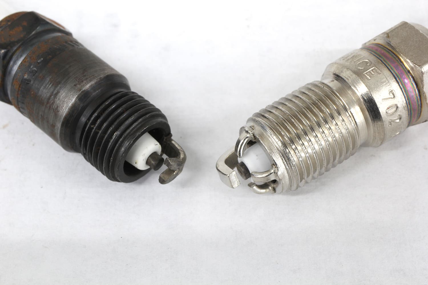 007 Two spark plugs compared—one with a black oxide finish and another with a multi ground electrode design