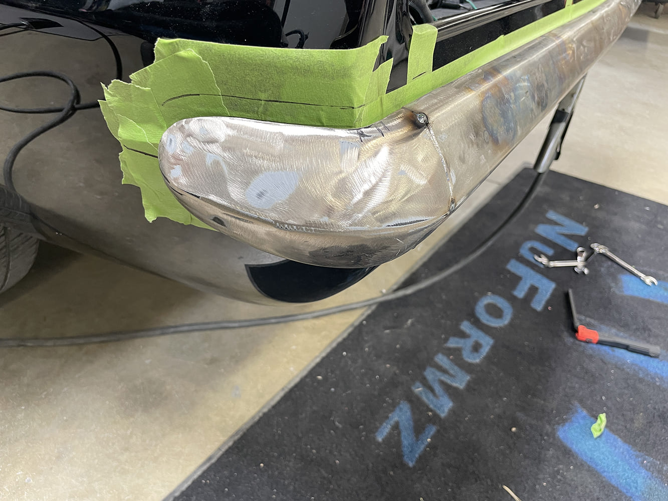 010 1969 Camaro rear bumper tack welded and contoured to body lines with guide tape for shaping
