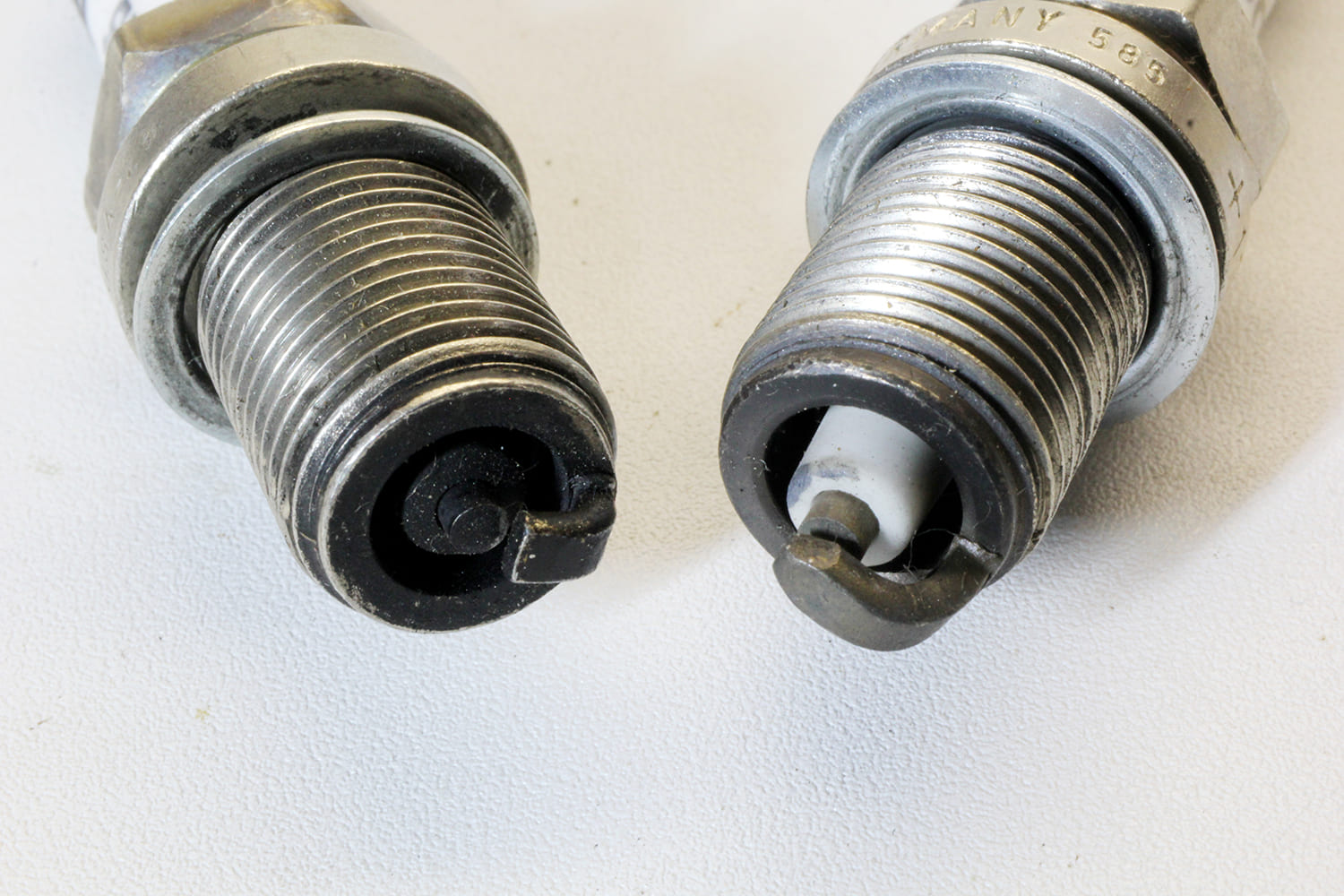 010 Side by side view of standard vs fine wire spark plugs showing different electrode configurations and wear patterns