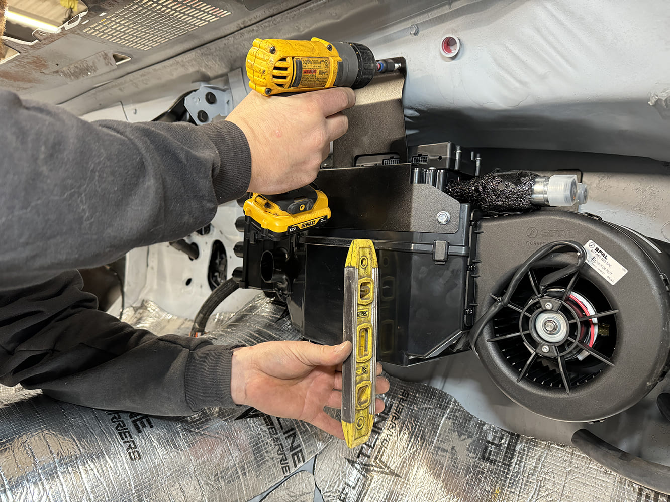 011 Using a level and drill to secure HVAC unit mounting bracket in the 1971 Camaro