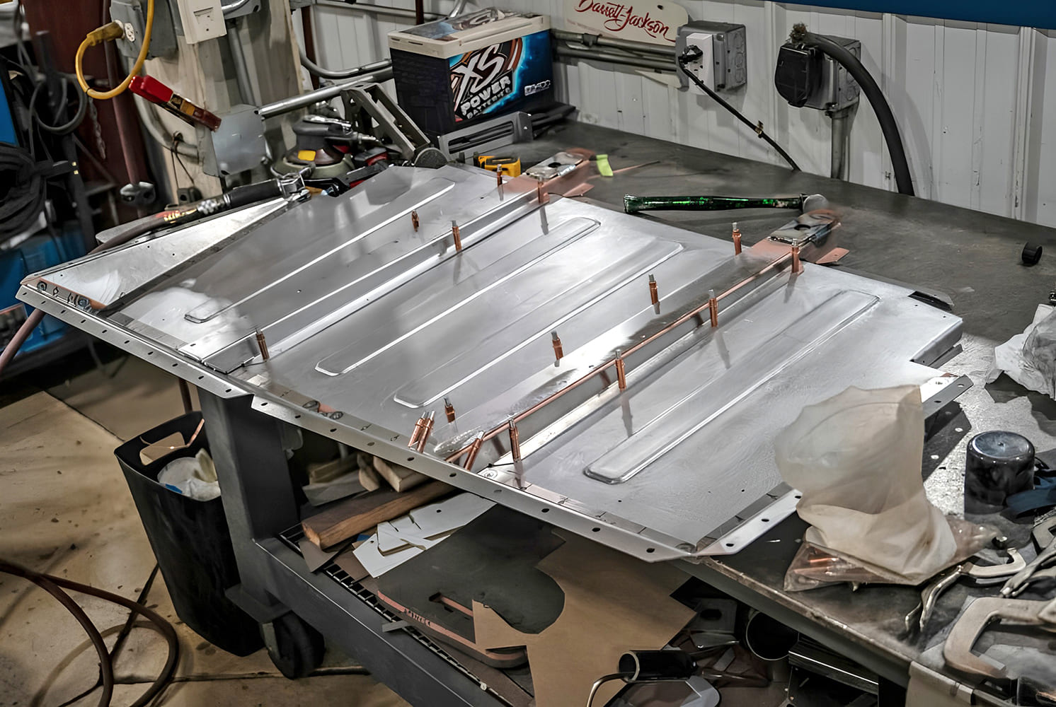 012 1968 Camaro trunk floor panel mocked up with Cleco pins for alignment on fab bench