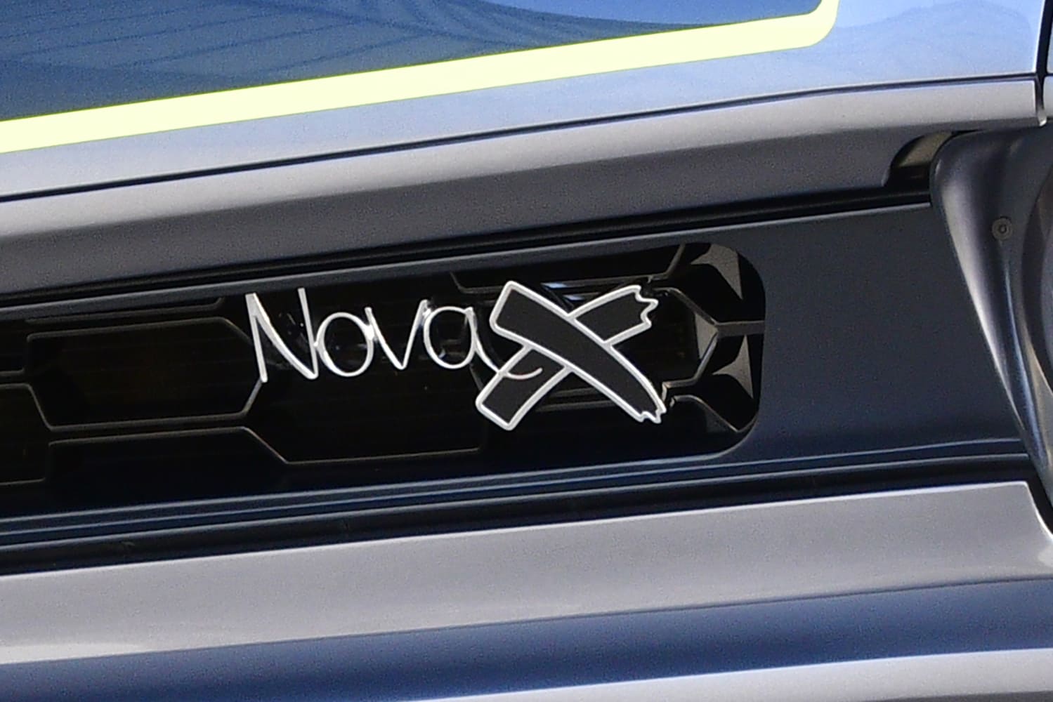 015 1968 Chevy Nova grille badge showcases Nova X branding in chrome and black