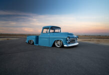 02 1957 Chevy truck turquoise stepside pickup with smoothed body lines and chrome grille at sunset