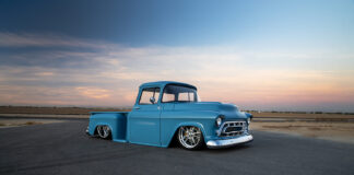 02 1957 Chevy truck turquoise stepside pickup with smoothed body lines and chrome grille at sunset