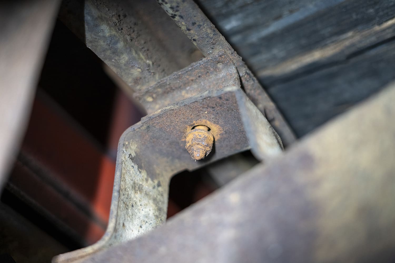 02 Close up of rusted factory bed bolt and support bracket from under the C10 bed