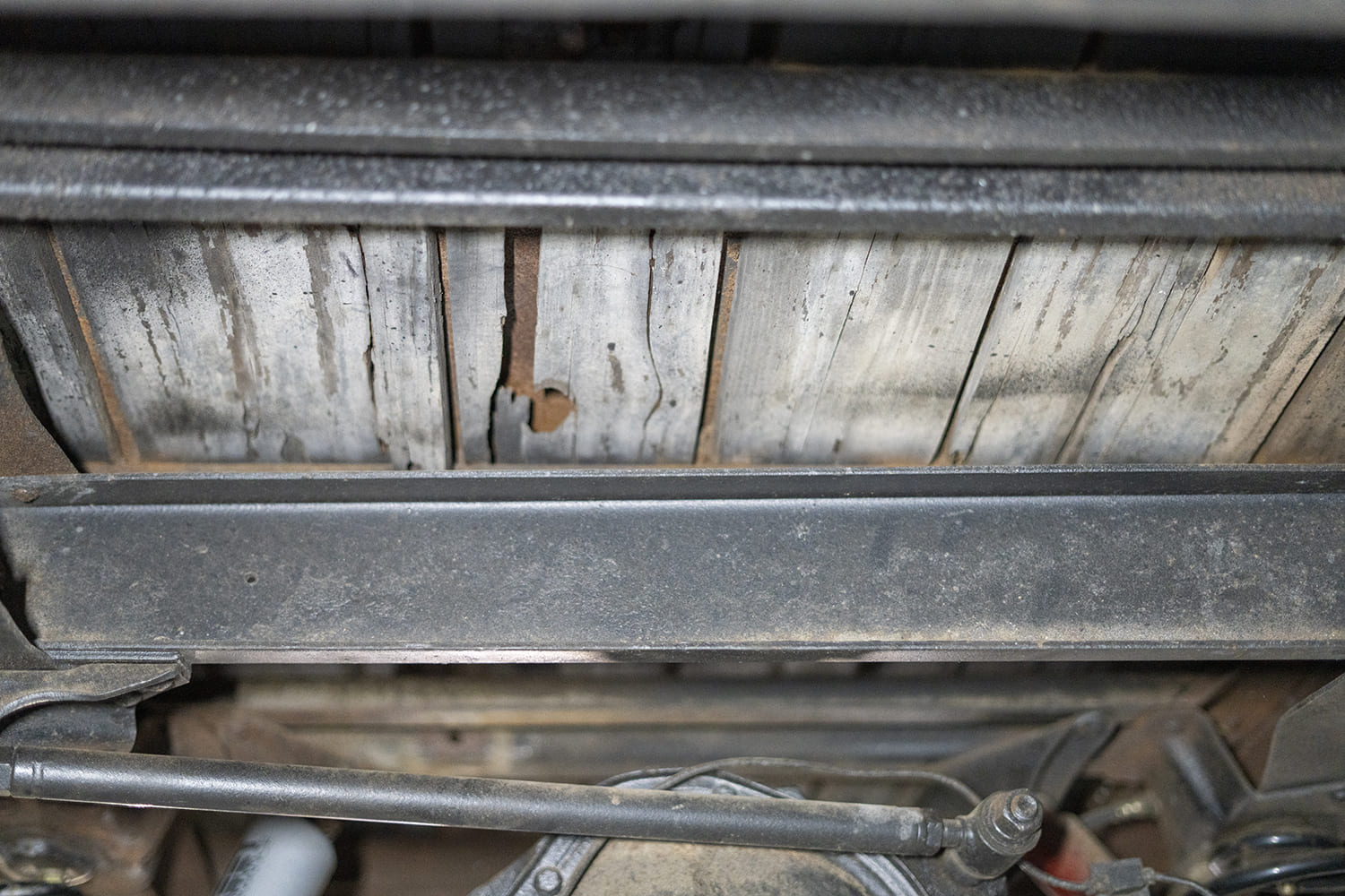 03 View from below of deteriorated original wood bed slats needing replacement on the C10