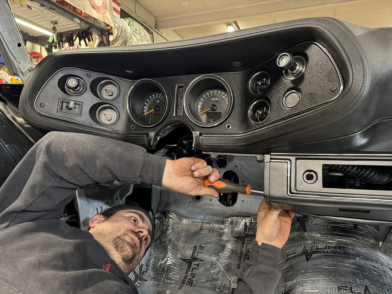 030 Tightening dash bezel screws to secure the gauge panel in the 1971 Camaro interior