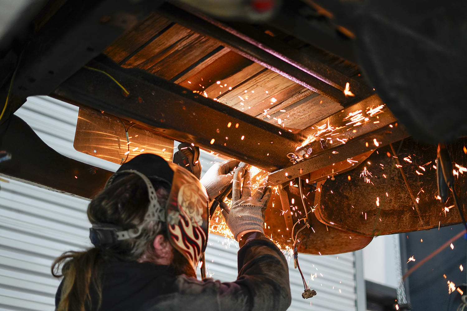 04 Sparks fly as a fabricator cuts steel supports under the C10 bed for new floor installation