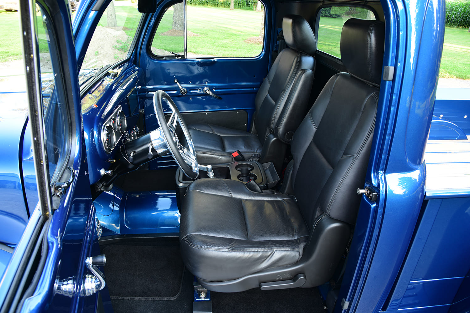 08 Modern bucket seat interior in 1950 Ford F1 with center console and black leather upgrade