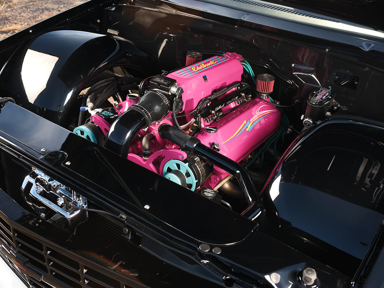 10 1993 Chevy OBS engine bay with hot pink Edelbrock valve covers teal pulleys and custom pinstriping