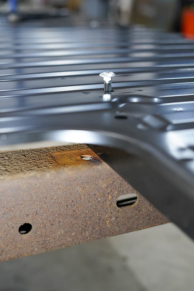10 A carriage bolt is fitted through the new steel bed floor panel and aligned to the C10’s frame rail