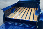 11 1950 Ford F1 features a show quality oak bed floor with stainless strips and a deep blue finish