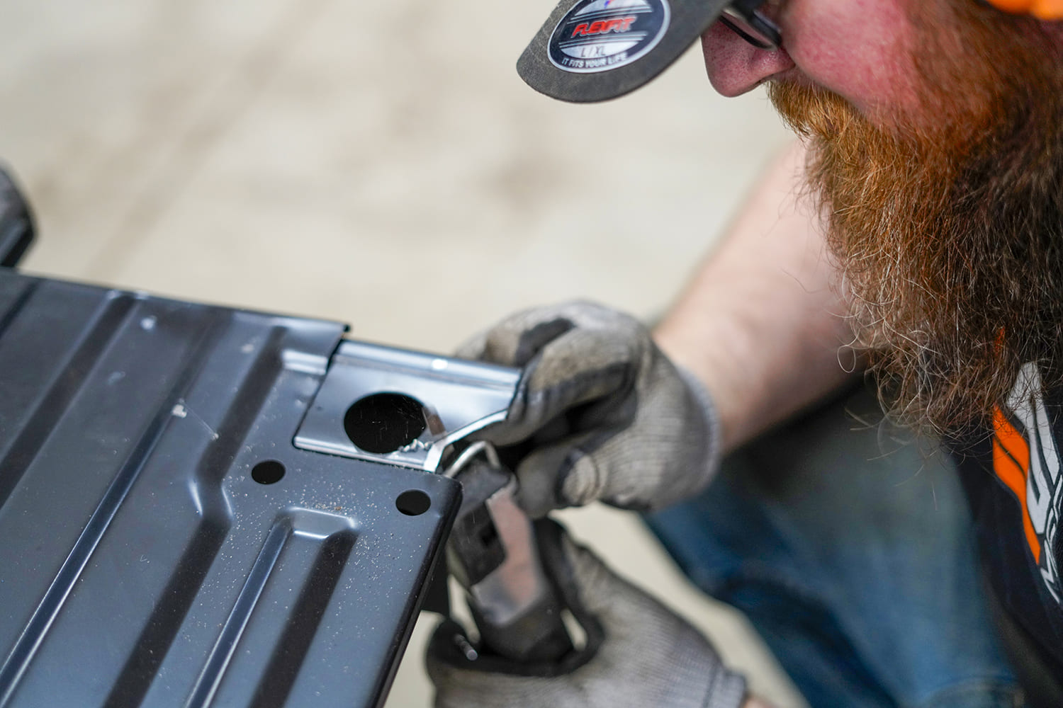 14 Using a rotary tool builder trims the edge of a pre marked steel bed section for clearance