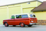 18 1966 Chevy Suburban shows dual barn doors and custom orange steel wheels with Chevy caps