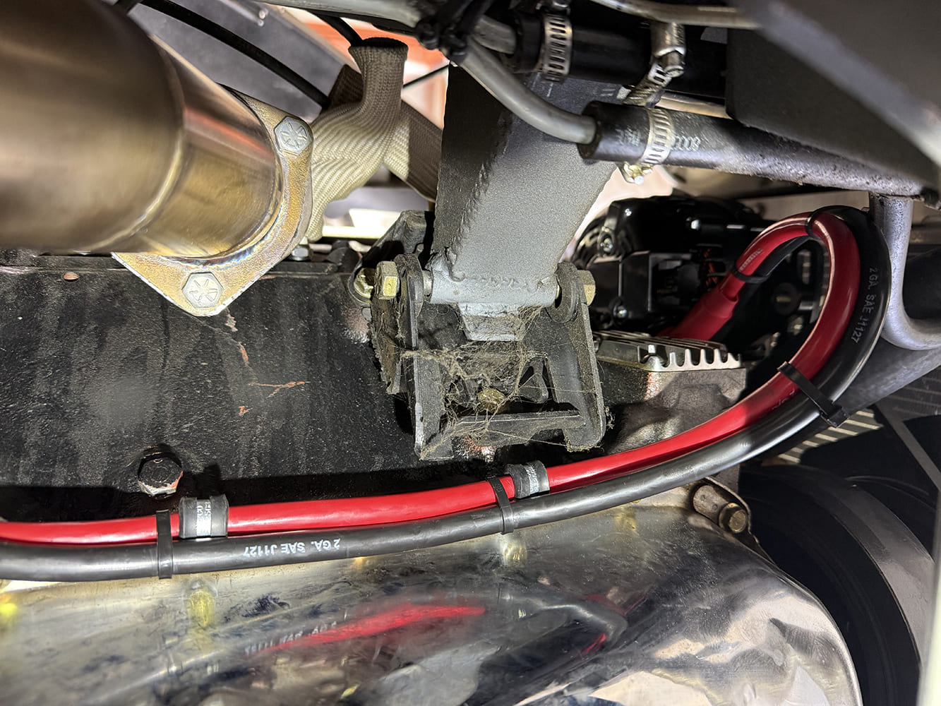 21 Red and black battery cables routed neatly along transmission tunnel using insulated P clamps
