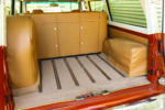 22 1966 Chevy Suburban rear cargo area lined with carpet stainless rails and hidden storage cabinetry