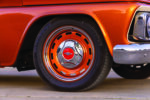 23 1966 Chevy Suburban rides on painted steel wheels with Continental tires and red Chevy hubcaps