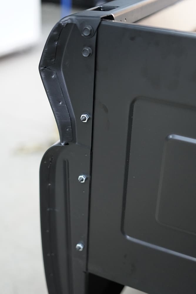24 Corner view of tail panel highlights new hardware and fresh fitment against the new steel bed side