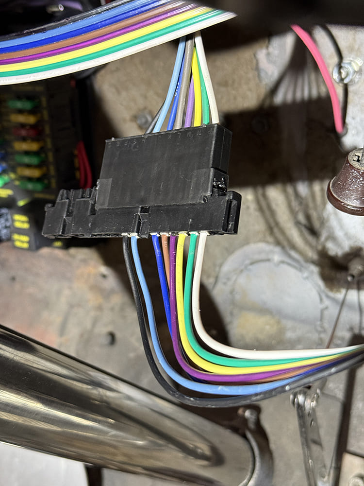32 Column plug secured to under dash fuse panel with clean wire organization