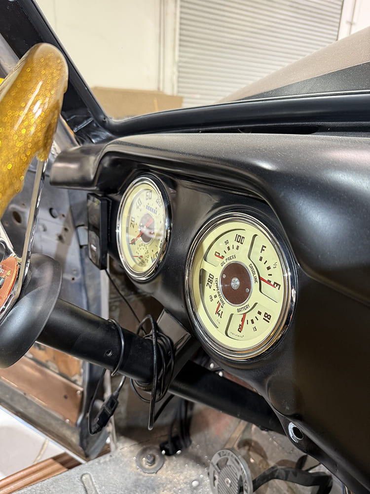 41 Full dash view showing dual gauge pods and custom steering wheel in 1948 Chevy truck