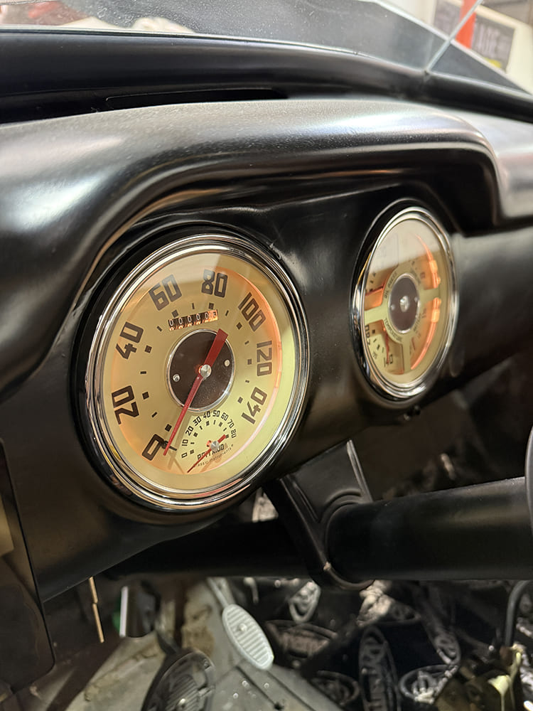 46 Backlit gauge cluster glowing amber inside the finished dash panel