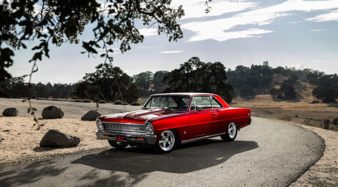001 1966 Chevy Nova in candy red with Billet Specialties wheels and lowered stance on a mountain road