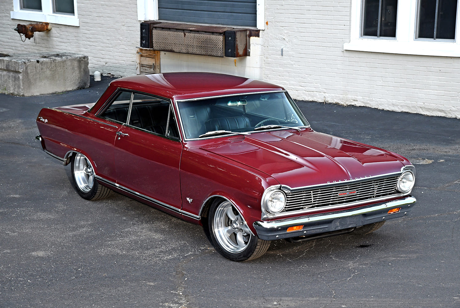 002 1965 Chevy Nova front angle showing clean chrome bumper and tucked performance stance