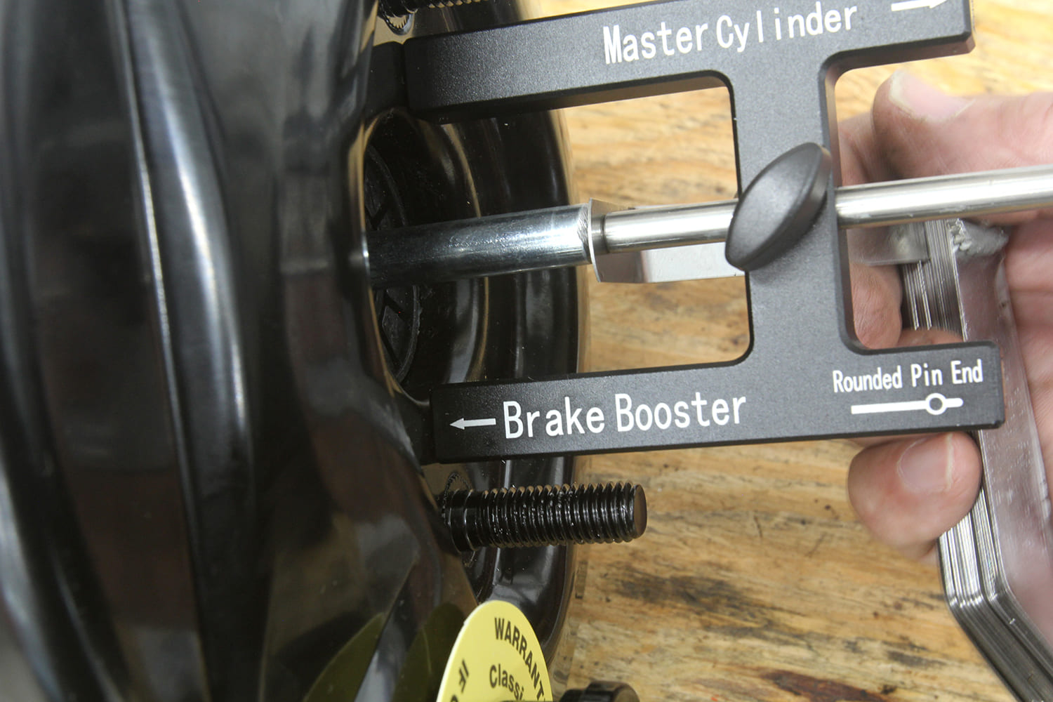 003 Tool inserted into booster to verify pin length matches master cylinder