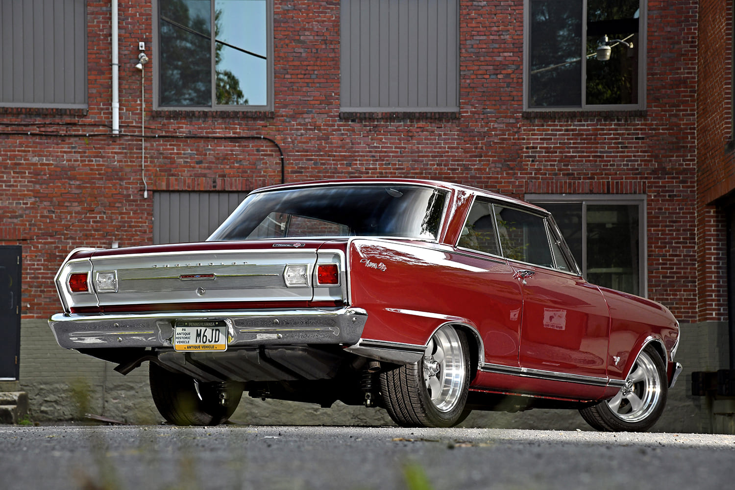 004 1965 Chevy Nova low rear angle showing mini tubbed quarters and dual exhaust