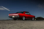006 1966 Chevy Nova street machine from rear angle tucking chrome wheels under lowered suspension