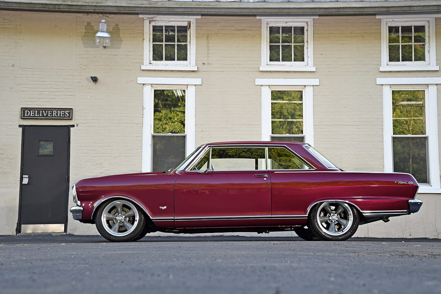 008 1965 Chevy Nova side profile in burgundy with modern five spoke wheels and lowered look