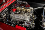 008 1966 Chevy Nova engine bay features triple carb V8 with Chevrolet valve covers and custom plumbing