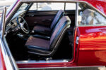 010 1966 Chevy Nova interior has black and maroon bucket seats floor shifter and custom steering wheel