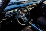 011 1966 Chevy Nova interior features a Chevy branded steering wheel and modern dash insert with digital display