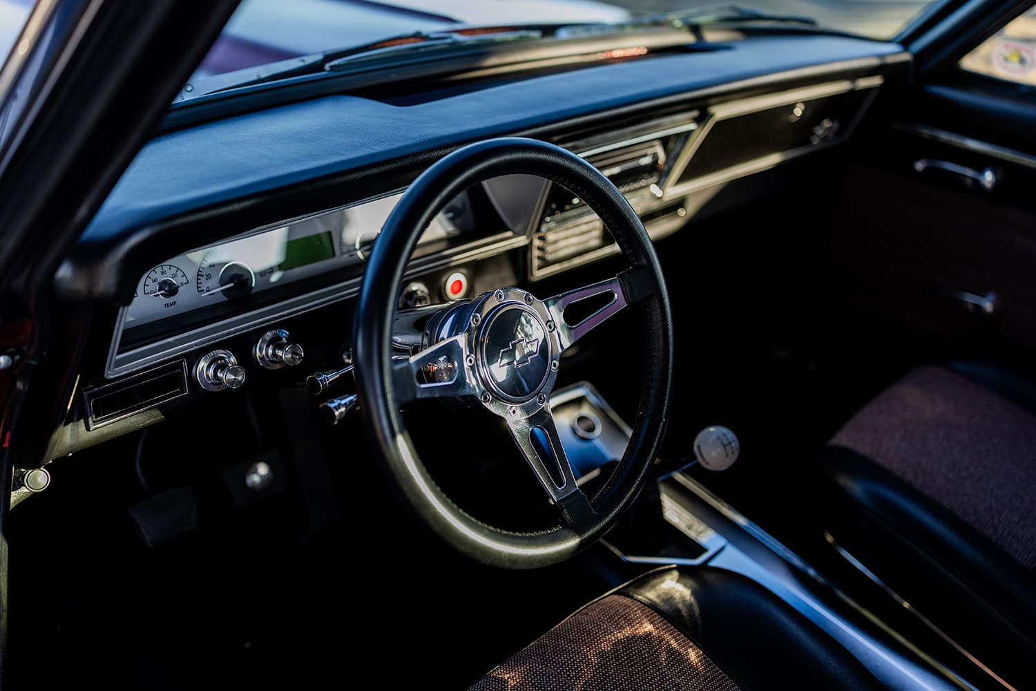 011 1966 Chevy Nova interior features a Chevy branded steering wheel and modern dash insert with digital display