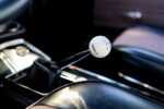 013 1966 Chevy Nova Hurst shifter with white cue ball knob adds classic muscle car feel to the console