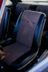 014 1966 Chevy Nova bucket seat in black vinyl with maroon tweed insert and chrome seat trim