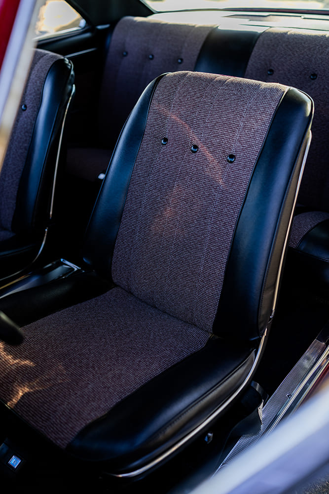 014 1966 Chevy Nova bucket seat in black vinyl with maroon tweed insert and chrome seat trim