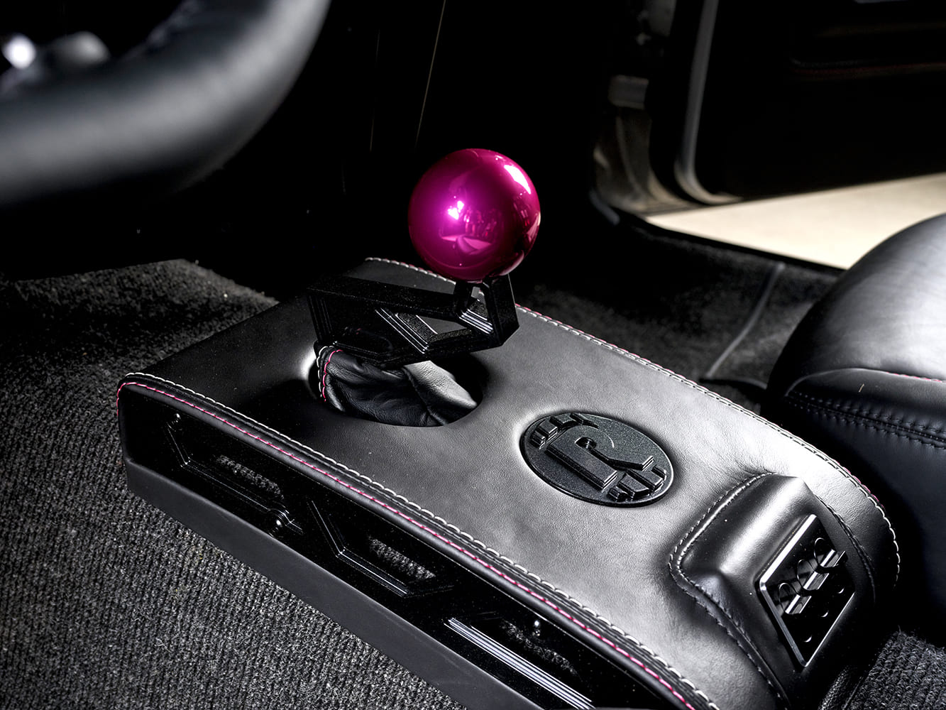016 1969 Chevy Nova center console sports a pink billet shifter and RRC badging